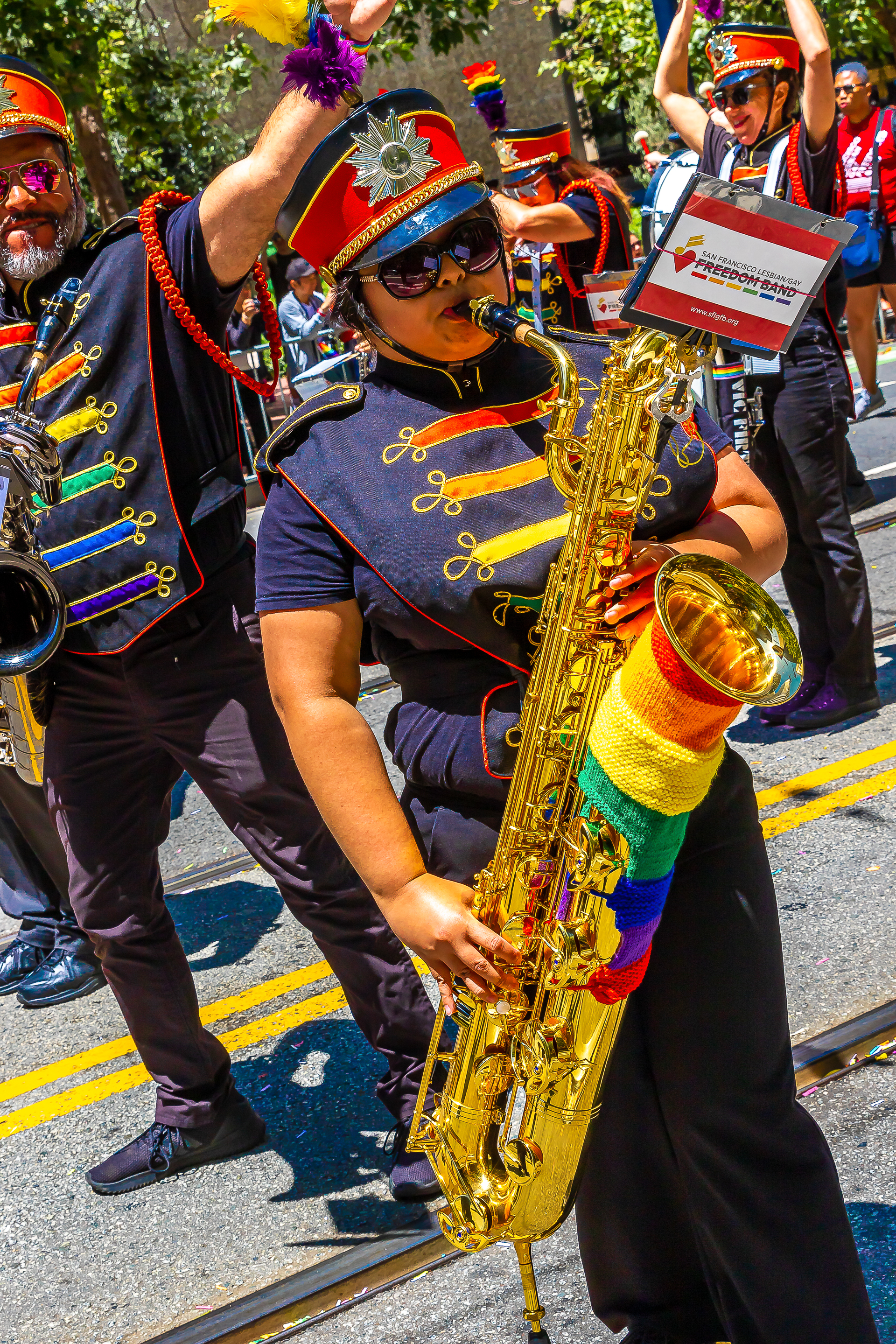 SF Pride Parade — band members and flag bearers under a blue sky